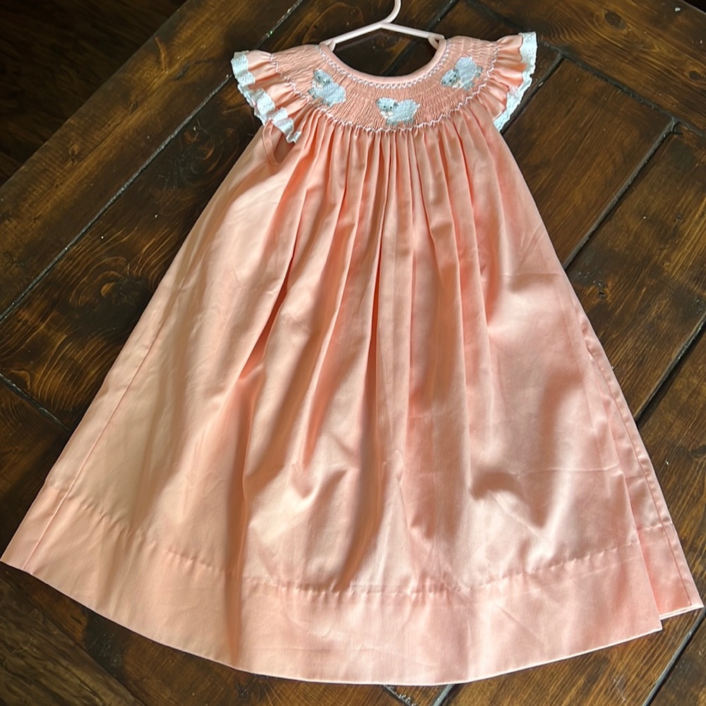Peach smocked little lamb dress.